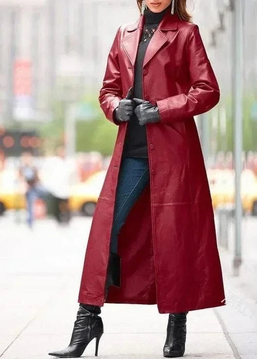 Person wearing a long red coat on a city street