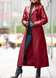 Person wearing a long red coat on a city street