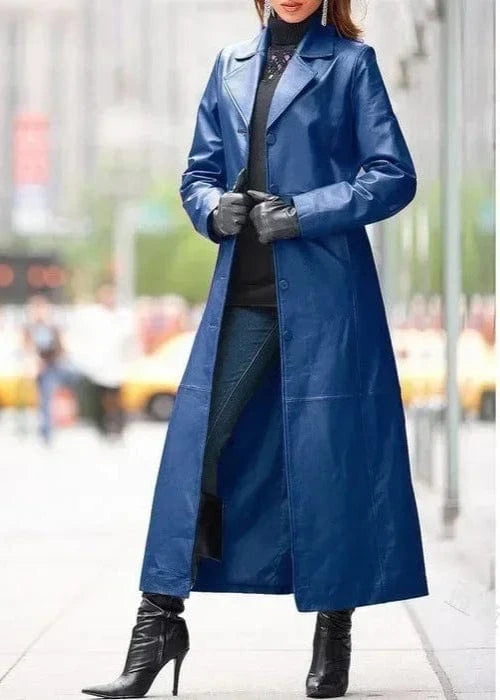 Person wearing a long blue coat on a city street