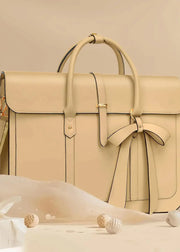 Beige handbag with a bow on a beige background