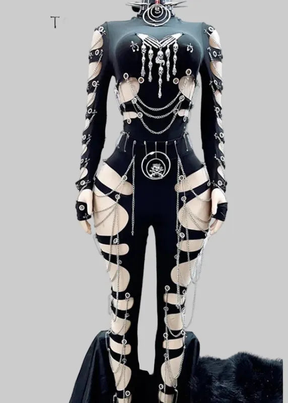 A gothic-style black bodysuit with beige cutout panels and extensive silver chain, collar, and belt details, displayed on a mannequin against a white background with the brand name AMY&BENTON in the top left corner.