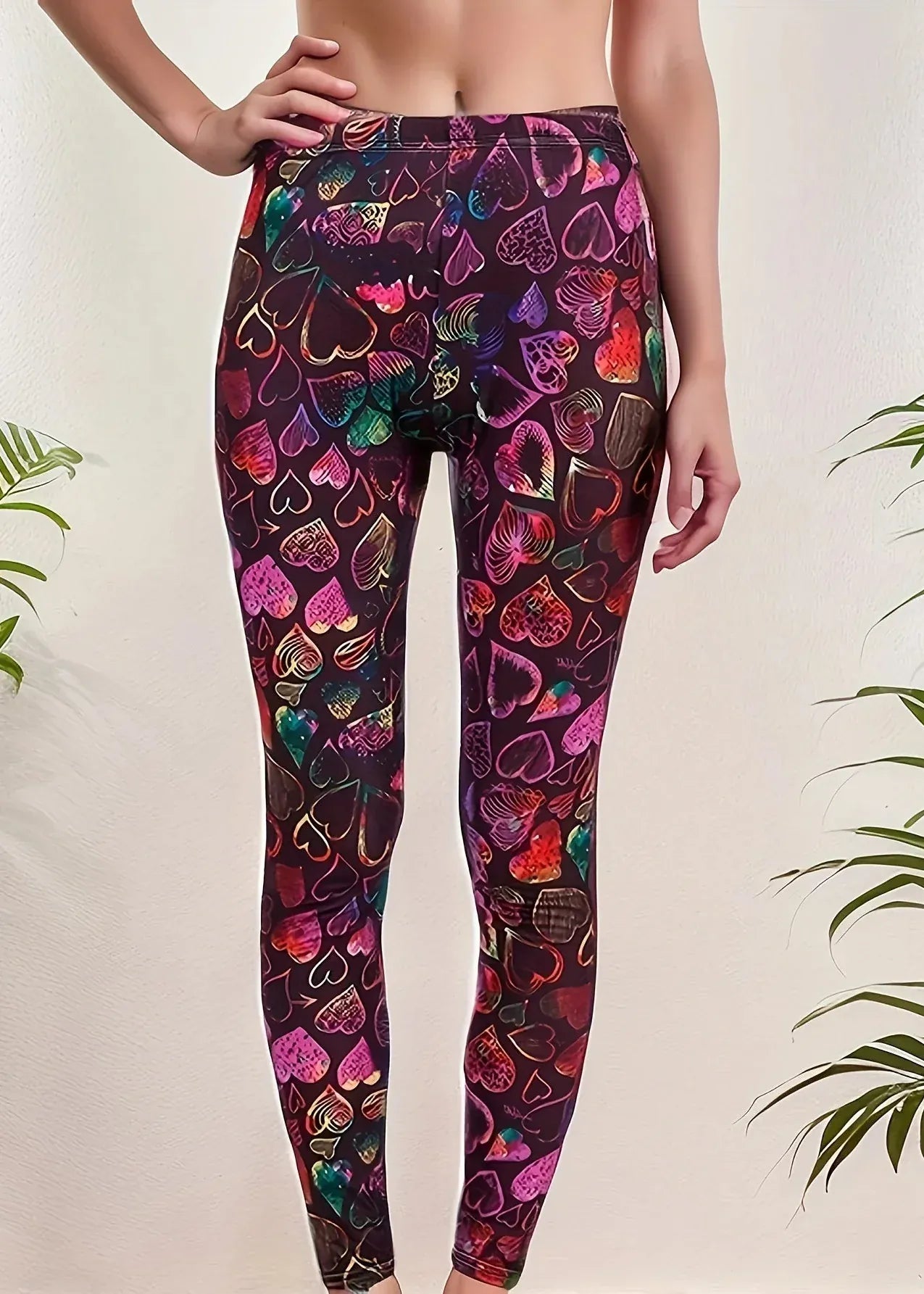 Leggings with colorful heart pattern worn by a person on a light background