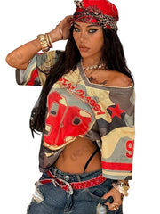 Woman wearing a colorful off-shoulder top with red and gray patterns, sitting indoors.