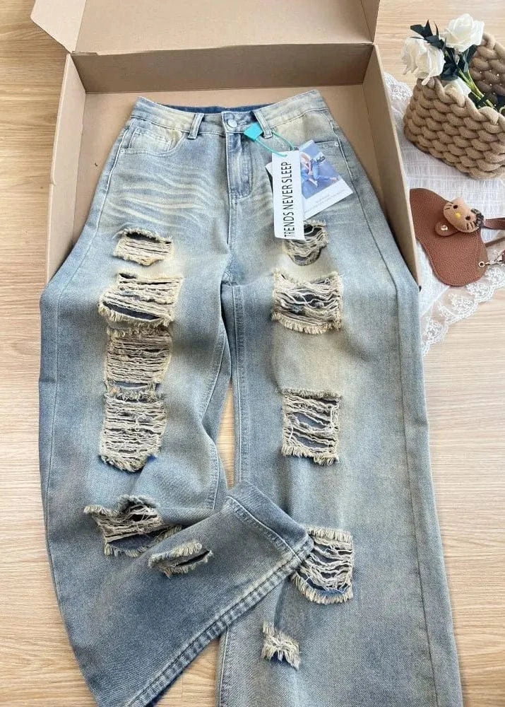 Ripped jeans with a tag on a wooden surface