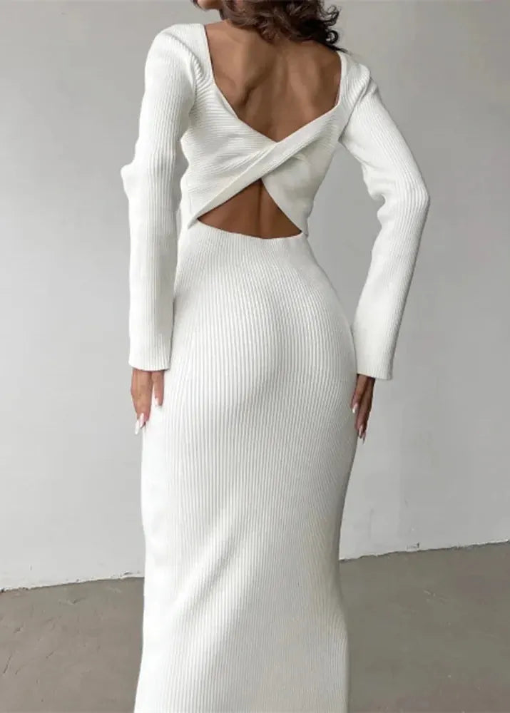 White ribbed dress with cut-out back design on a plain background