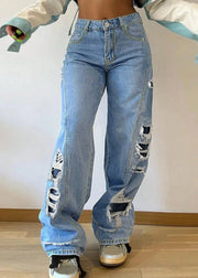 Person wearing ripped blue jeans on a plain background