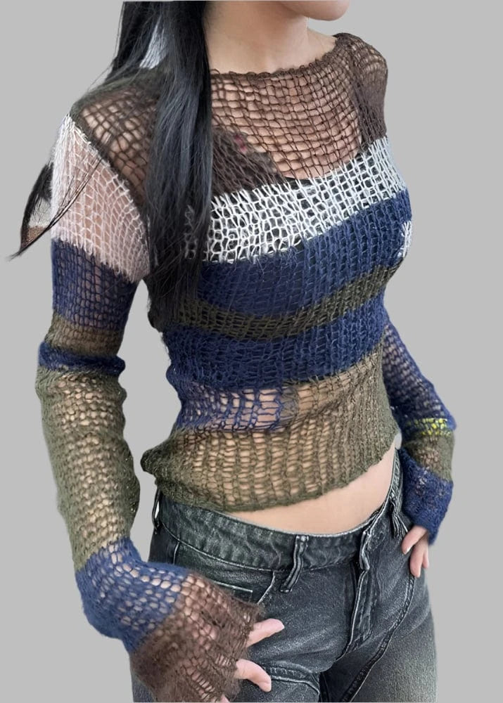 Person wearing a multicolored crochet sweater and jeans indoors.