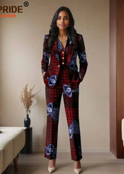 Woman wearing a patterned suit standing in a room with beige walls and a couch.