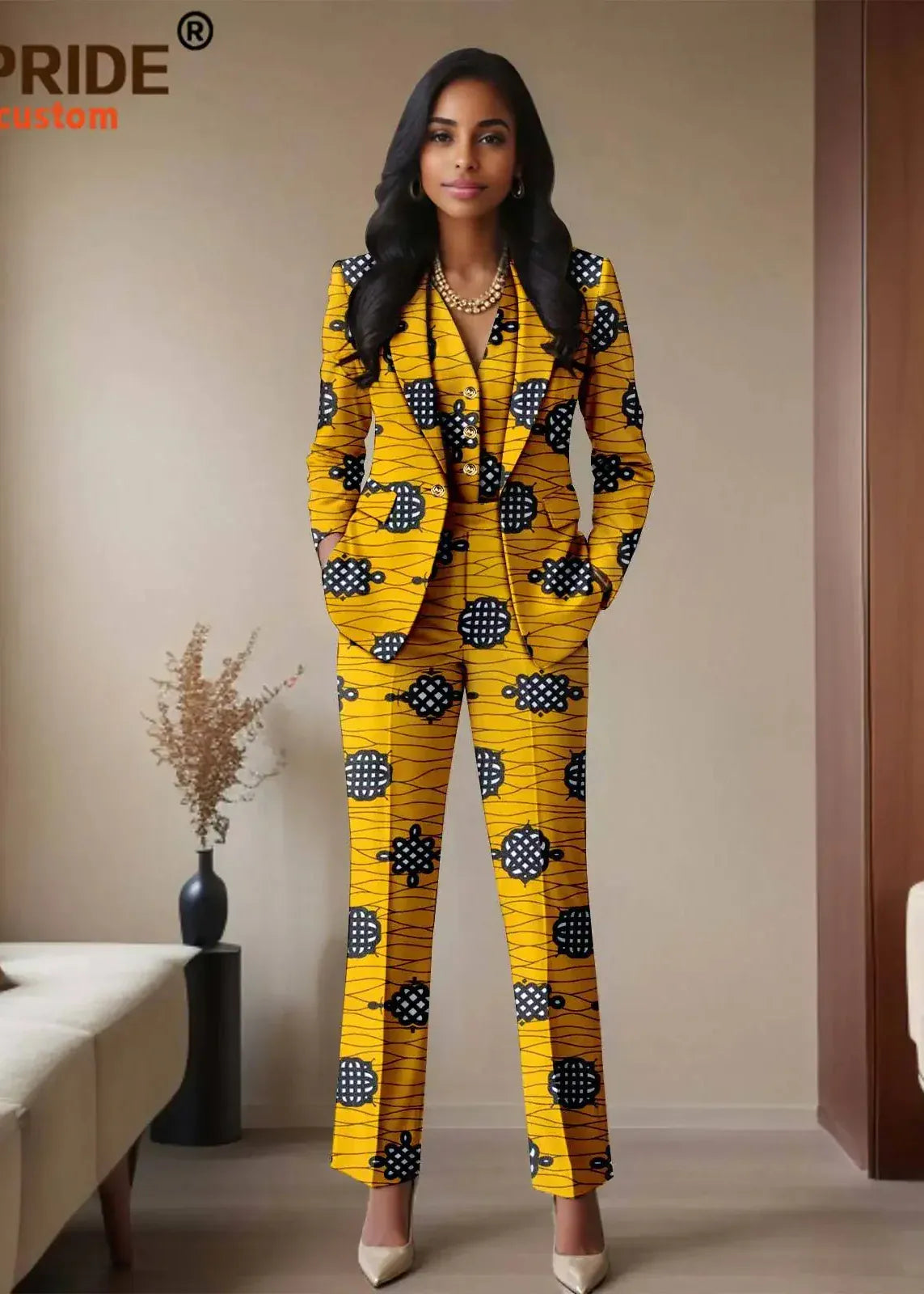Woman wearing a yellow patterned suit standing in a room with beige walls and a couch.