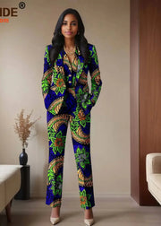 Woman wearing a colorful patterned suit in a room with a couch and vase.