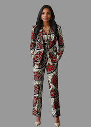 Woman wearing a patterned suit standing in a living room.