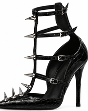Black stiletto sandal with multiple wrap-around straps, pointed toe, and silver metal spikes, shown on a plain white background.