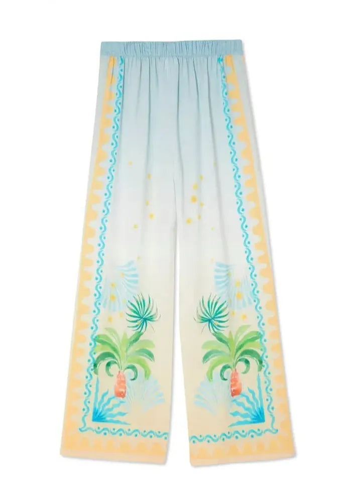 Pants with palm tree and beach scene design on a white background