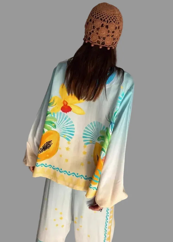 Person wearing a colorful floral scarf with a plain background