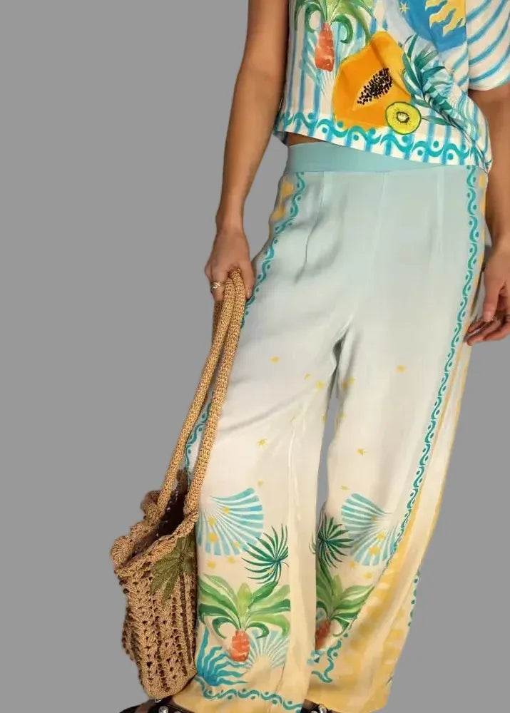 Person wearing a colorful outfit with floral patterns and holding a woven bag.