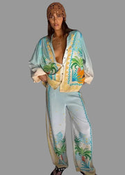 Woman wearing a colorful outfit with floral patterns on a plain background
