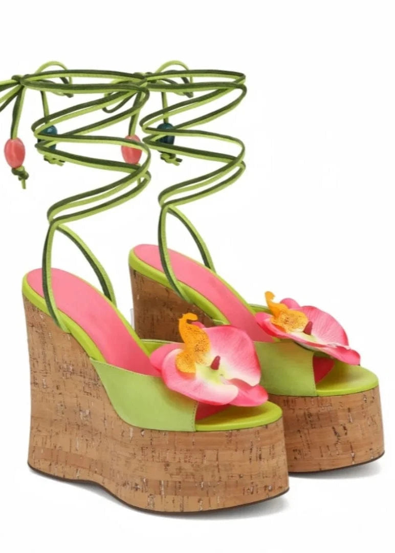 Colorful wedge sandals with floral details on a white background