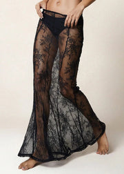Black lace sheer pants being worn by a person on a neutral background