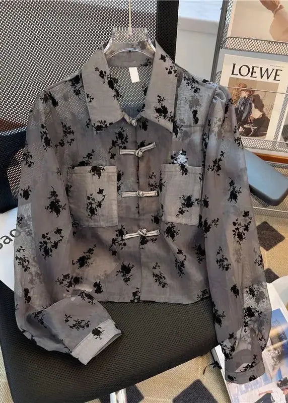 Floral patterned shirt on a chair with magazines in the background