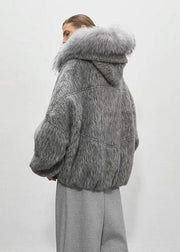 Person wearing a gray fur coat with a hood on a white background