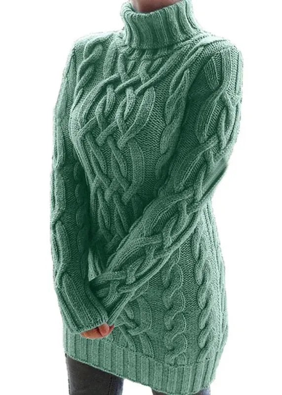 Green cable knit sweater on a white background
