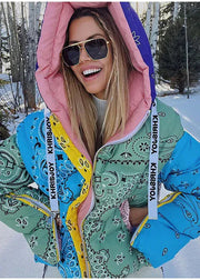 Person wearing a colorful jacket with a bandana design in a snowy outdoor setting