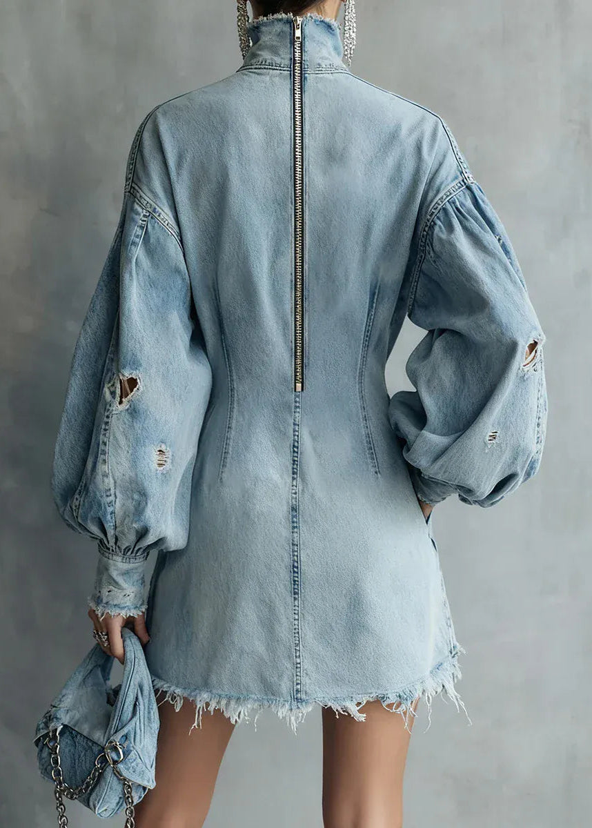 Light blue denim dress with distressed details on a gray background