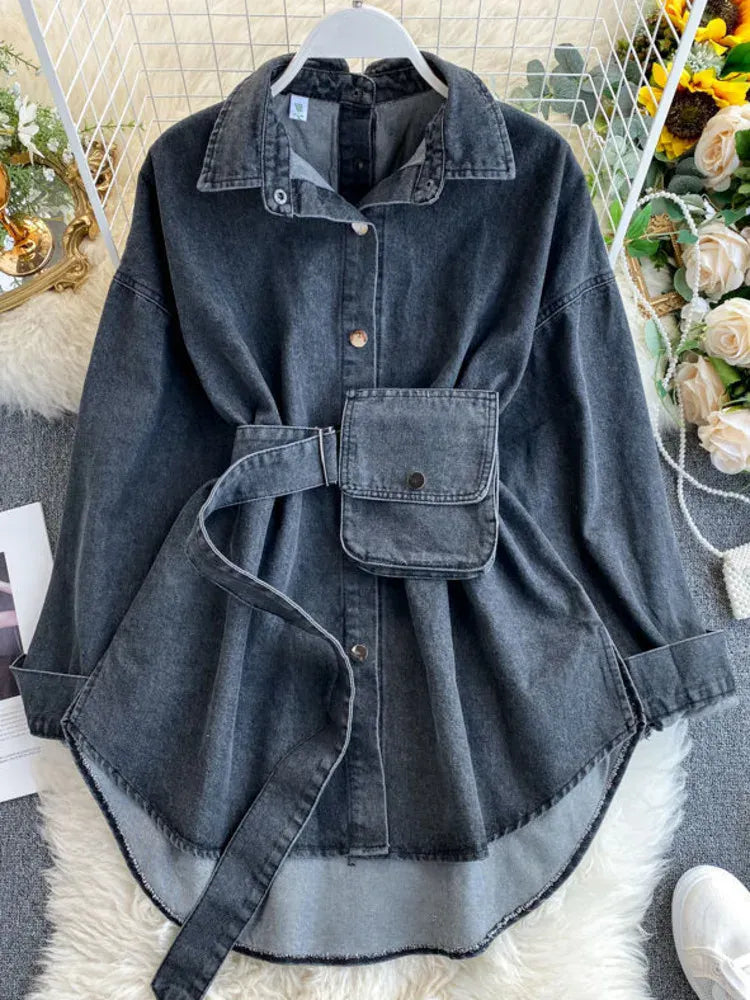 Denim jacket with a belt on a hanger against a decorative background