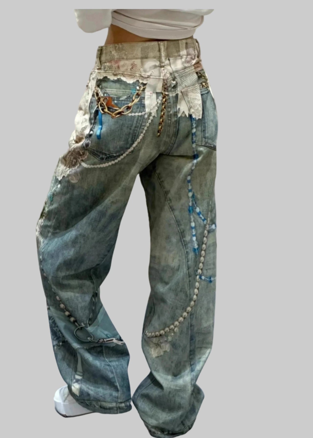 Distressed jeans with patches and embellishments on a plain background