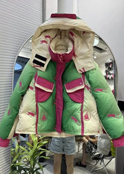 Green and beige puffer jacket with pink accents on a mannequin against a mirror background.