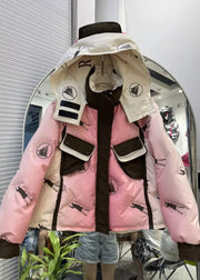 Pink and beige puffer jacket with black graphics on a mannequin in front of a mirror.
