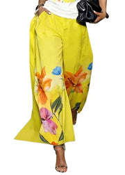 Yellow floral pants worn by a person on a white background