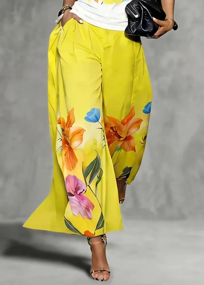 Yellow floral pants worn by a person on a gray background