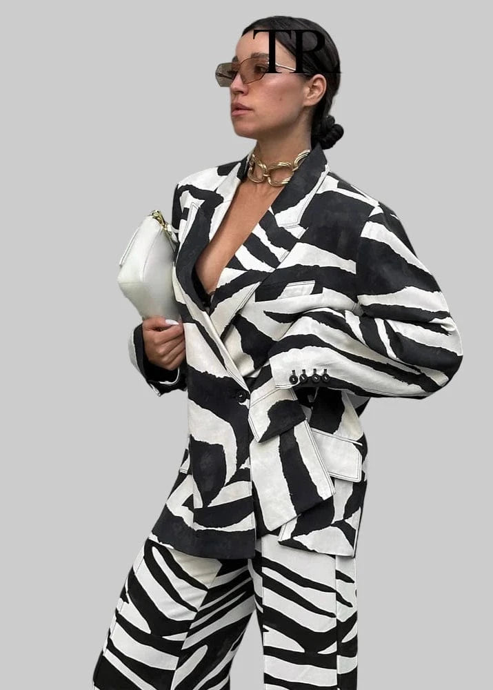 Person wearing a black and white patterned outfit with 'Trafza' branding.