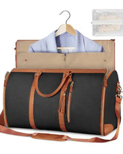 Black travel bag with brown accents, clothes on a hanger, and a clear pouch inside.