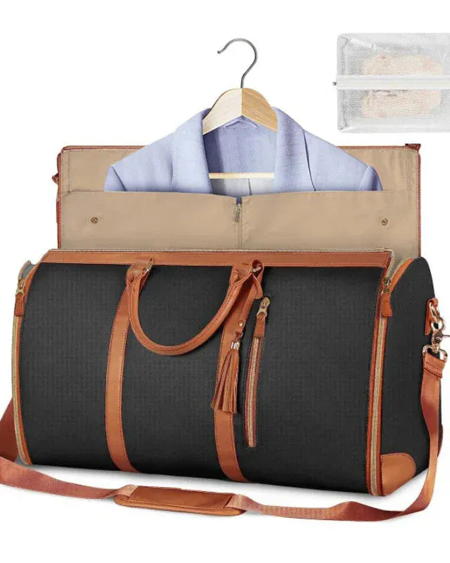 Black travel bag with brown accents, clothes on a hanger, and a clear pouch inside.